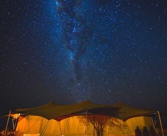 The Milky Way shines above the dining tent
